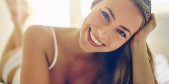 smiling model laying down on stomach